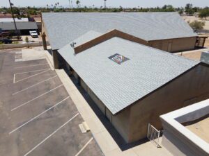 Professional crew performing commercial roofing in Phoenix on a large business complex.