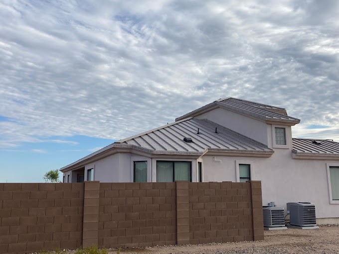 metal roofing contractors near me installing a standing seam metal roof in Phoenix